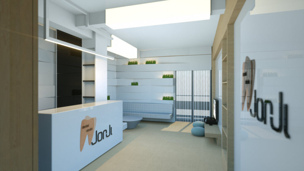 A brightly lit, modern dental studio reception area with a sleek dark and light brown reception desk featuring the "Jorji" logo. The waiting area includes comfortable blue chairs and a minimalist design with white walls accented by a green textured wall paneling. The space conveys a clean and welcoming atmosphere. By Modify Architects