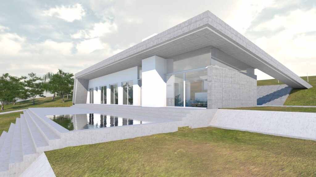 A low-angle exterior view of a modern, minimalist residence featuring a flat concrete roof extending over white walls and large glass windows. The house is set into a grassy hillside with a reflecting pool in front of the entrance, accessed by a series of concrete steps. Trees are visible on the left side of the frame, and a bright, cloudy sky provides the backdrop. By Modify Architects