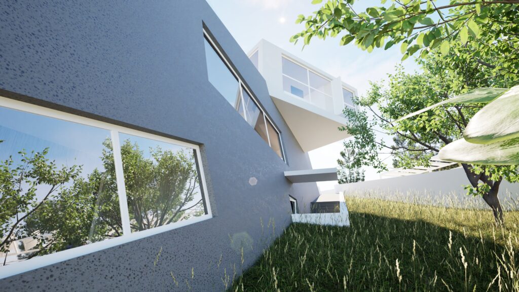 A low-angle view of a modern house with a dark gray textured exterior and angular design, featuring large windows reflecting lush greenery, set amidst tall grass and trees under a bright blue sky. By Modify Architects