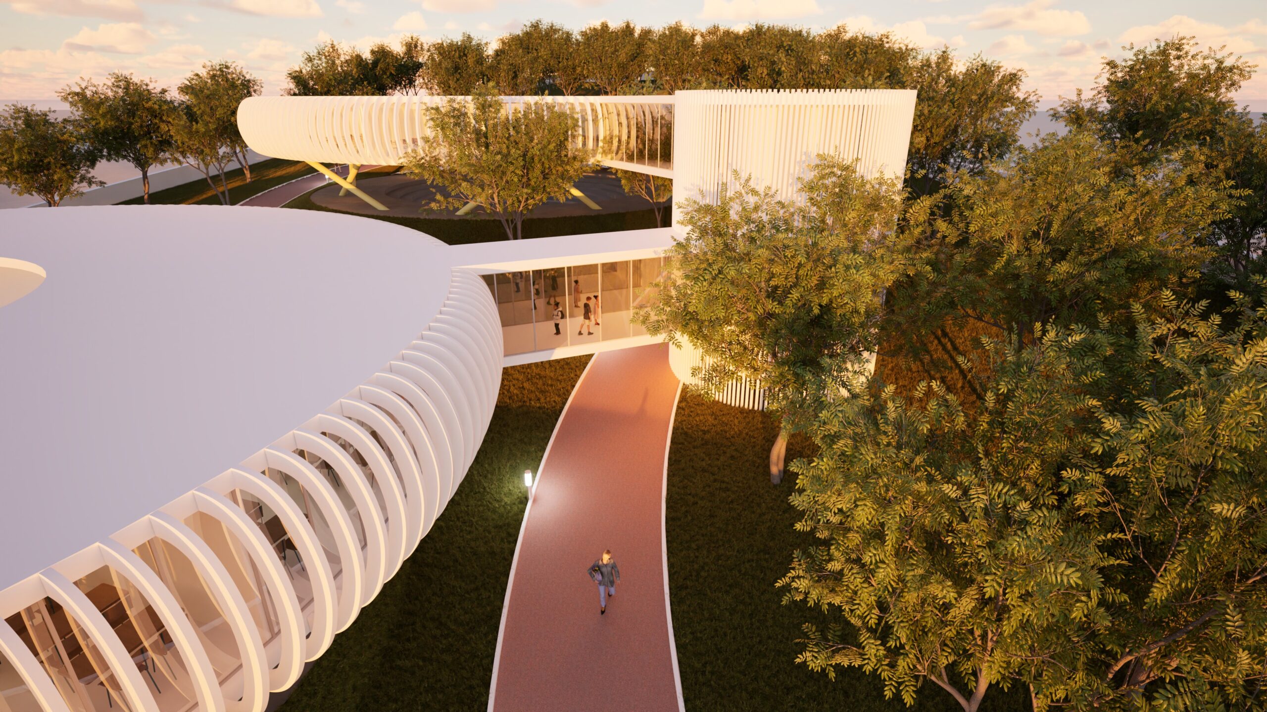 Aerial view of the "Education Rings" school complex, showcasing a modern architectural design with curved, white buildings connected by glass walkways. A red pathway leads through lush greenery, with a person walking towards the building, emphasizing the integration of education with nature and a welcoming campus environment. The image is rendered with a warm, sunset lighting, highlighting the building's form and surrounding landscape. By Modify Architects